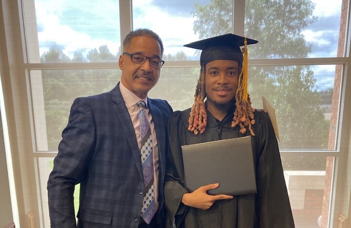 Opelika Housing Authority CEO Matthew McClammey and Montravious Turpin in cap and gown at Southern Union ceremony