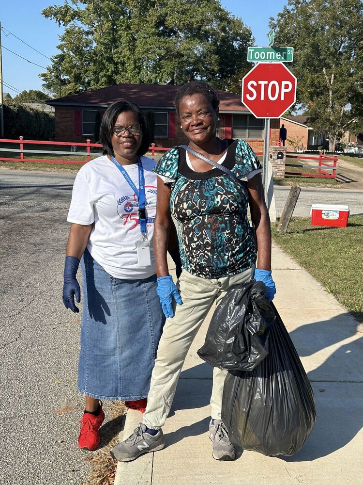 Opellka Housing Authority Staff member and resident of Ward 1 at the community cleanup event