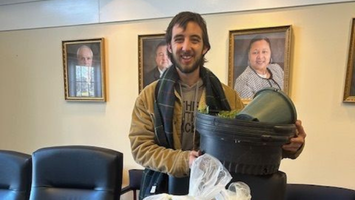 O Grows Market staff member posing with donations in our board room